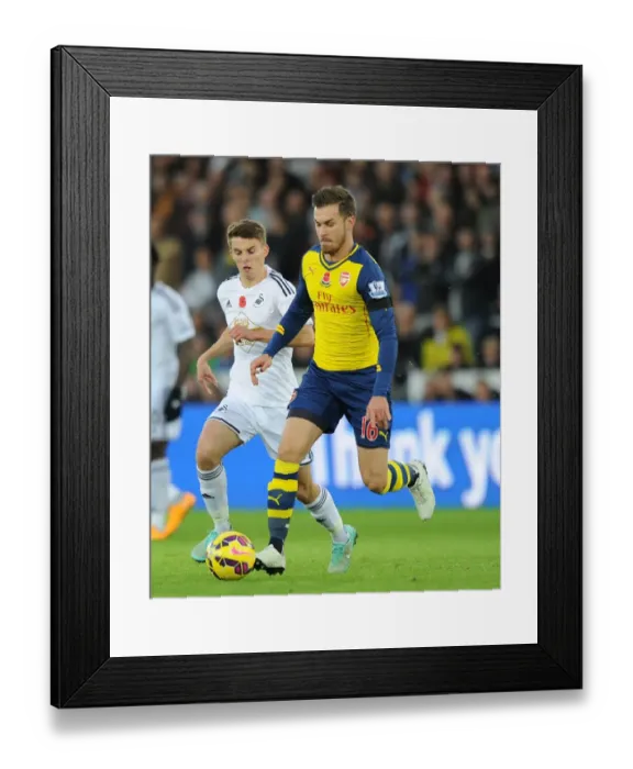Framed Print : Arsenal's Aaron Ramsey Outmaneuvers Swansea's Tom Carroll