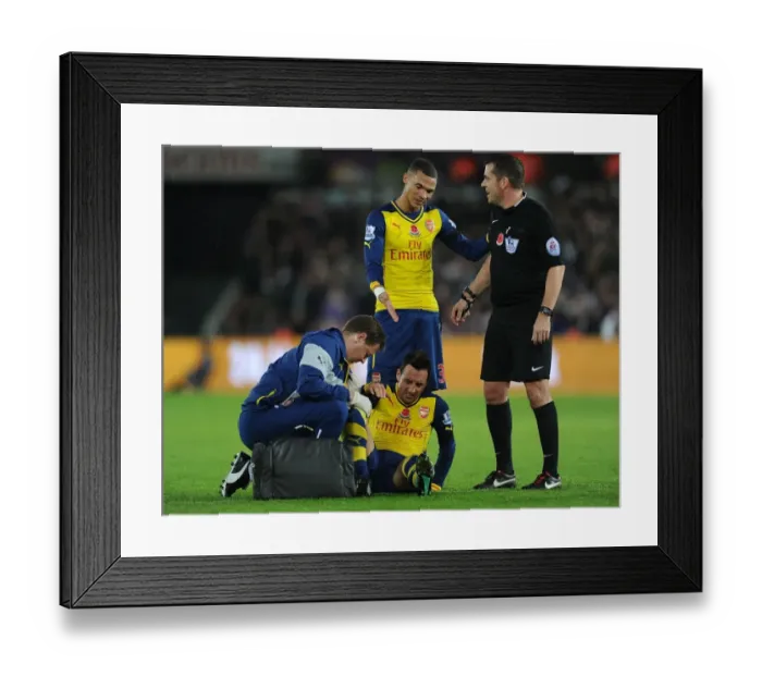 Framed Print : Arsenal's Santi Cazorla Receives Treatment from Physio Amid Swansea Tussle Framed Print : Arsenal's Santi Cazorla Receives Treatment from Physio Amid Swansea Tussle