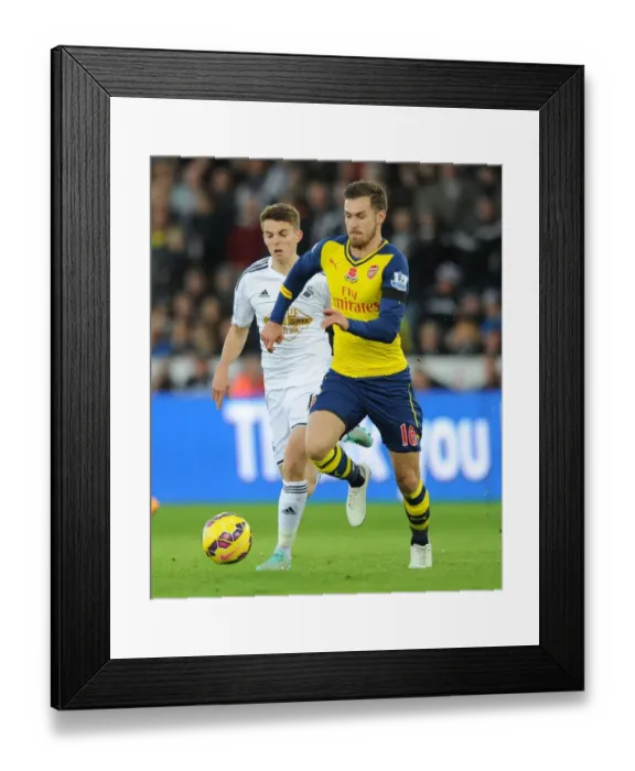Framed Print : Aaron Ramsey's Sneaky Moves: Outsmarting Tom Carroll in Swansea Derby