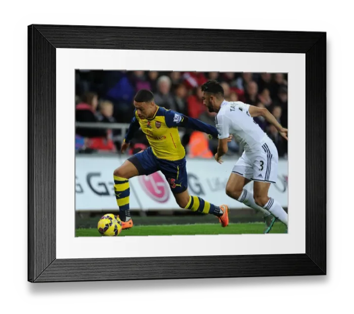 Framed Print : Arsenal's Oxlade-Chamberlain Outmaneuvers Swansea's Taylor in Premier League Clash (Swansea v Arsenal 2014-15) Framed Print : Arsenal's Oxlade-Chamberlain Outmaneuvers Swansea's Taylor in Premier League Clash (Swansea v Arsenal 2014-15)