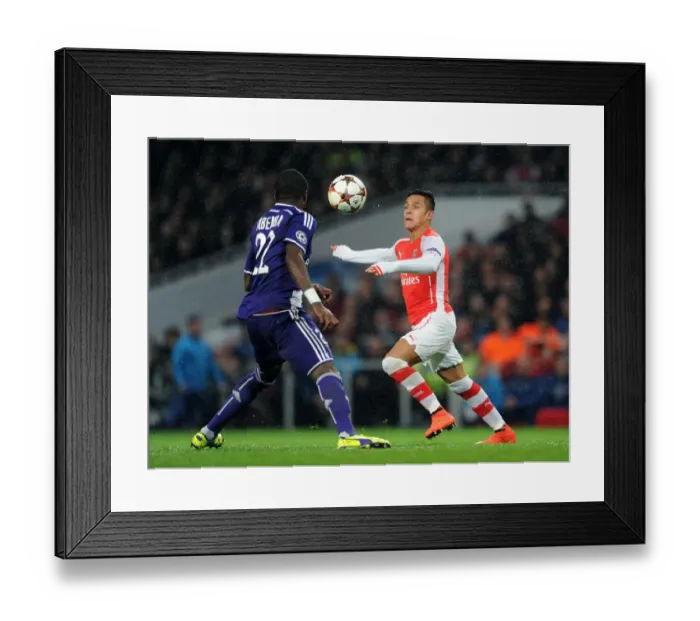 Framed Print : Arsenal's Alexis Sanchez Outmaneuvers Chancel Mbemba in Champions League Clash