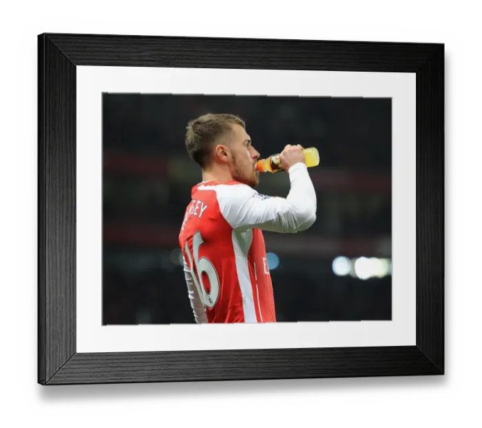 Framed Print : Arsenal's Aaron Ramsey Sips Gatorade Before Kickoff Against Manchester United in Emirates Stadium Framed Print : Arsenal's Aaron Ramsey Sips Gatorade Before Kickoff Against Manchester United in Emirates Stadium