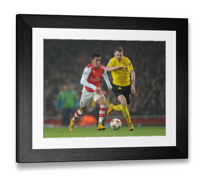 Framed Print : Clash of Stars: Sanchez vs. Piszczek - Arsenal vs. Borussia Dortmund, UEFA Champions League