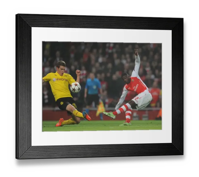 Framed Print : Arsenal's Yaya Sanogo Faces Off Against Matthias Ginter in Champions League Clash Framed Print : Arsenal's Yaya Sanogo Faces Off Against Matthias Ginter in Champions League Clash