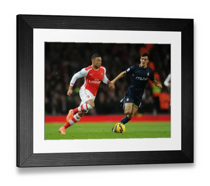 Framed Print : Arsenal's Oxlade-Chamberlain Clashes with Southampton's Cork in Premier League Showdown