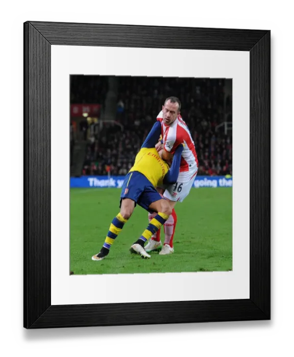 Framed Print : STOKE ON TRENT, ENGLAND - DECEMBER 06: Alexis Sanchez of Arsenal is fouled by Charlie Framed Print : STOKE ON TRENT, ENGLAND - DECEMBER 06: Alexis Sanchez of Arsenal is fouled by Charlie