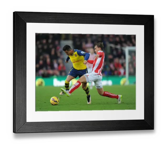 Framed Print : Alexis Sanchez Outmaneuvers Marc Muniesa: A Moment from the Stoke City vs. Arsenal Premier League Clash (2014-15)