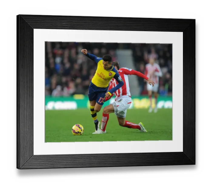 Framed Print : Sneaky Moves: Alexis Sanchez Outwits Marc Muniesa in the Stoke City vs. Arsenal Premier League Clash (2014-15)