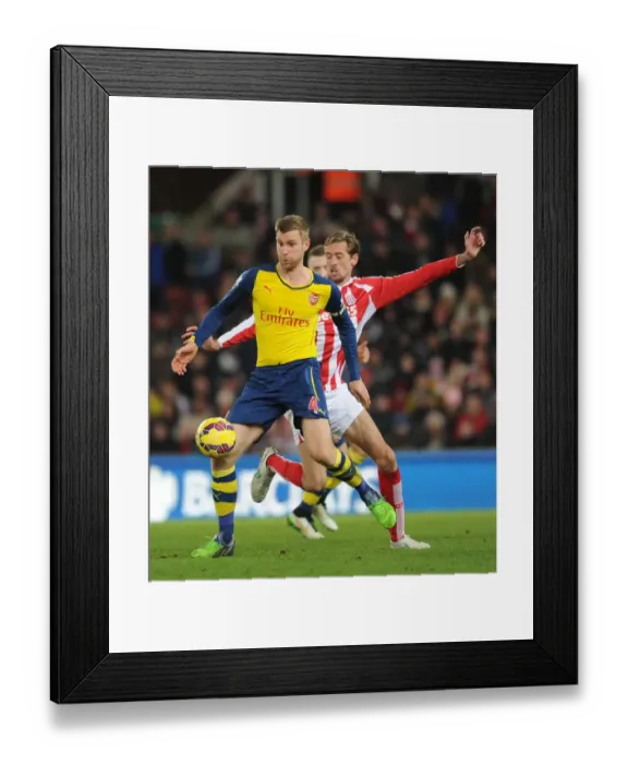 Framed Print : Per Mertesacker vs. Peter Crouch: A Battle at the Britannia Stadium (Stoke City vs. Arsenal, Premier League, 2014) Framed Print : Per Mertesacker vs. Peter Crouch: A Battle at the Britannia Stadium (Stoke City vs. Arsenal, Premier League, 2014)