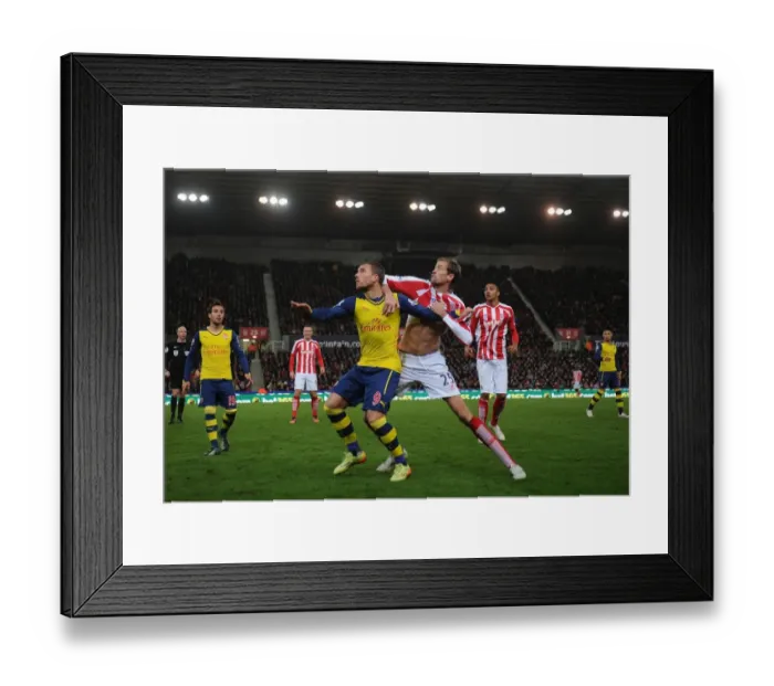 Framed Print : Podolski vs Crouch: Intense Battle at Britannia Stadium - Stoke City vs Arsenal, Premier League 2014-15