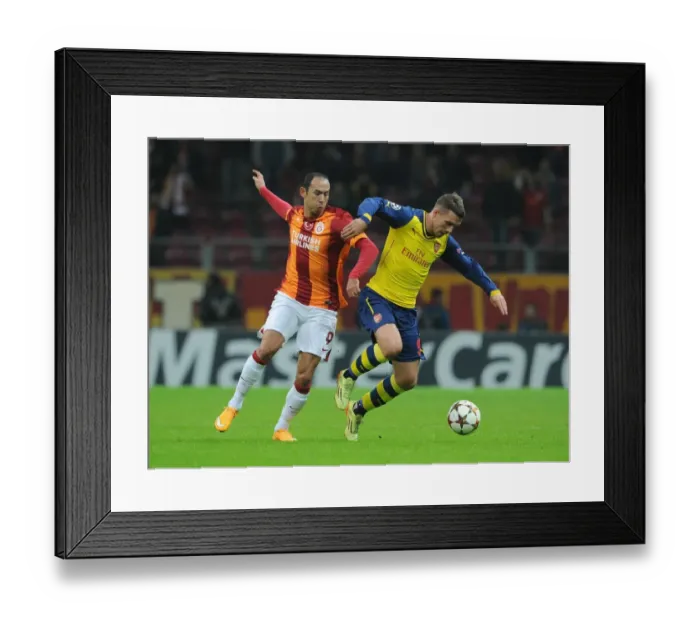 Framed Print : Lukas Podolski vs. Umut Bulut: A Battle in the UEFA Champions League between Galatasaray and Arsenal