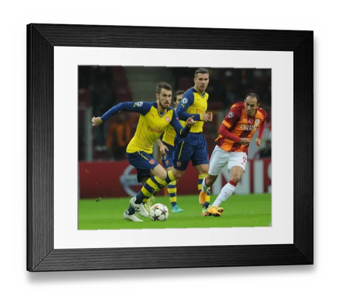 Framed Print : Arsenal's Aaron Ramsey Faces Off Against Galatasaray's Umut Bulut in UEFA Champions League Clash Framed Print : Arsenal's Aaron Ramsey Faces Off Against Galatasaray's Umut Bulut in UEFA Champions League Clash