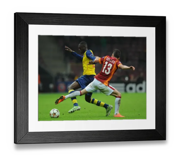 Framed Print : Arsenal's Aaron Ramsey Outwits Galatasaray's Alex Telles in UEFA Champions League Clash