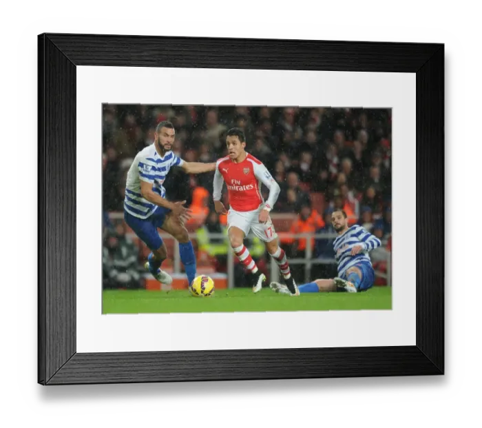 Framed Print : Arsenal's Alexis Sanchez Faces Off Against QPR's Steven Caulker and Niko Kranjcar