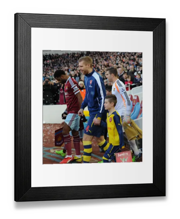 Framed Print : Per Mertesacker (Arsenal) with the mascot. West Ham United 1: 2 Arsenal. Barclays Premier League