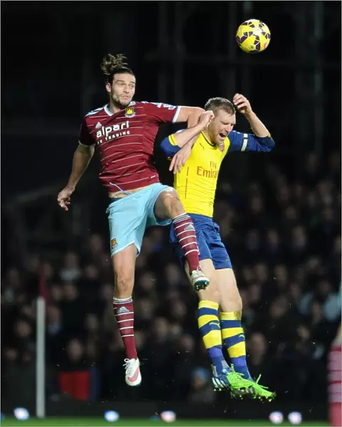 Per Mertesacker vs. Andy Carroll: Intense Battle in West Ham United vs. Arsenal Premier League Clash
