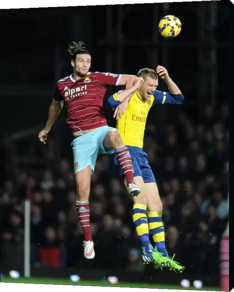 Per Mertesacker vs. Andy Carroll: Intense Battle in West Ham United vs. Arsenal Premier League Clash