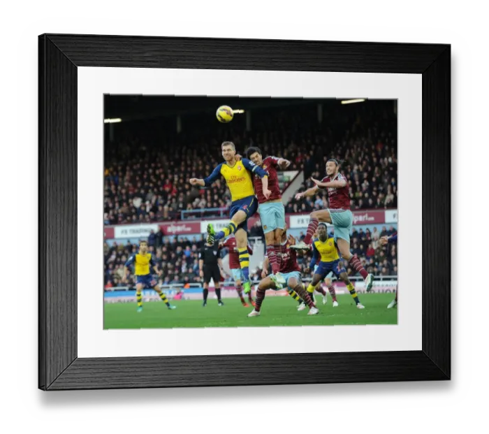 Framed Print : Clash at the Boleyn: Mertesacker Faces Off Against Carroll and Tomkins