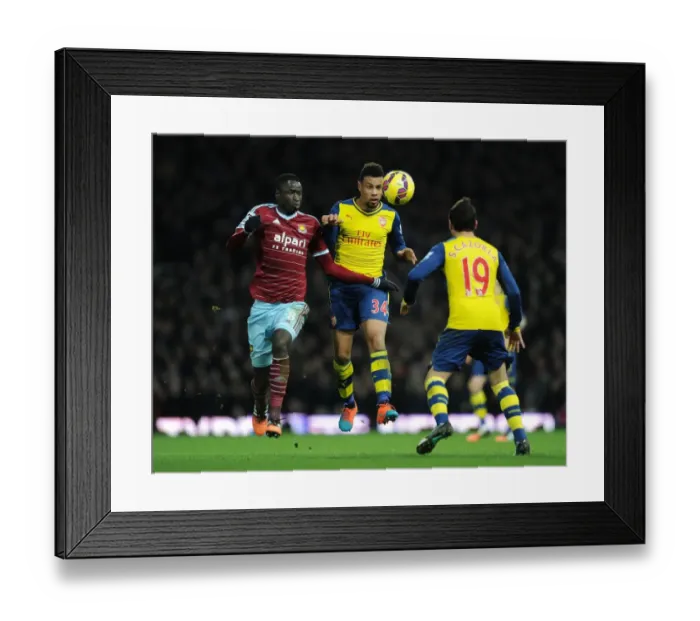 Framed Print : Coquelin vs. Kouyate: Intense Heading Battle Between Arsenal's Midfield Duo and West Ham's Defender Framed Print : Coquelin vs. Kouyate: Intense Heading Battle Between Arsenal's Midfield Duo and West Ham's Defender