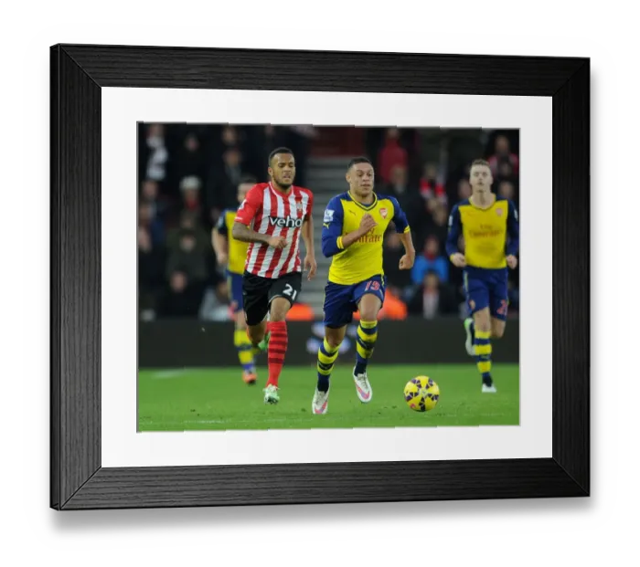 Framed Print : Intense Rivalry: Oxlade-Chamberlain vs. Bertrand Clash in Southampton vs. Arsenal Premier League Showdown (January 2015)