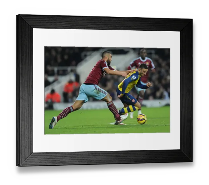 Framed Print : Arsenal's Oxlade-Chamberlain Outmaneuvers West Ham's Reid in Premier League Clash