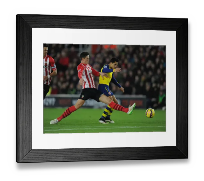 Framed Print : Arsenal's Alexis Sanchez Tripped by Southampton's Florin Gardos during Premier League Clash