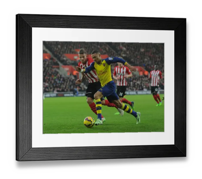 Framed Print : Arsenal's Kieran Gibbs Outmaneuvers Southampton's Toby Alderweireld in Premier League Clash (Southampton v Arsenal 2014-15)