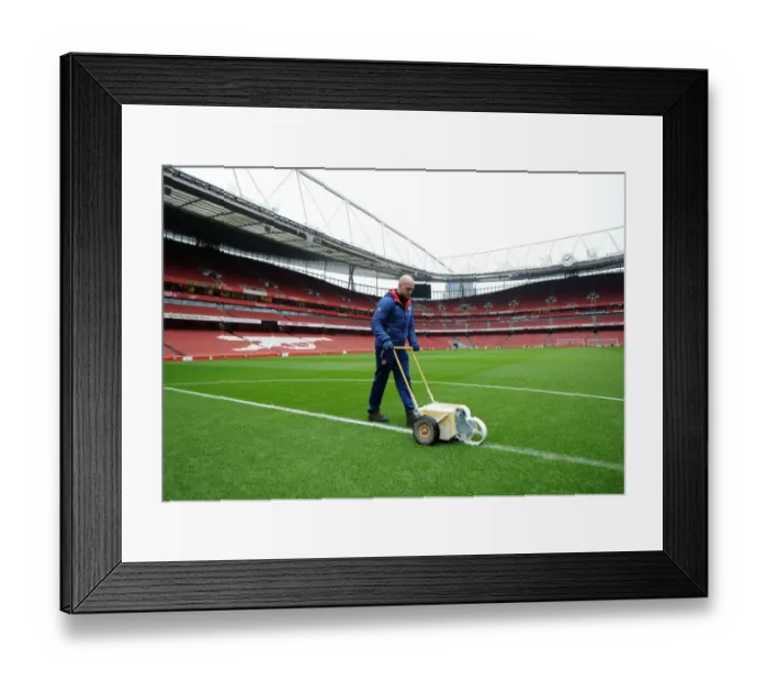 Framed Print : Arsenal Groundsman Prepares Pitch for FA Cup Match against Hull City