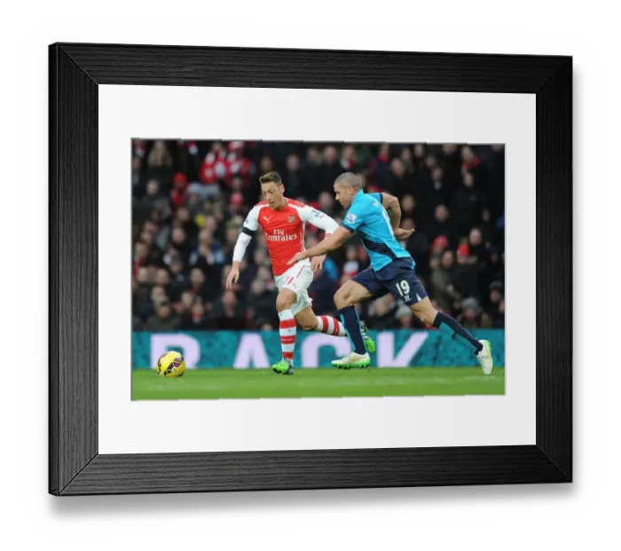 Framed Print : Mesut Ozil Breaks Past Stoke's Walters in Arsenal's Premier League Clash (Arsenal v Stoke City 2014-15)
