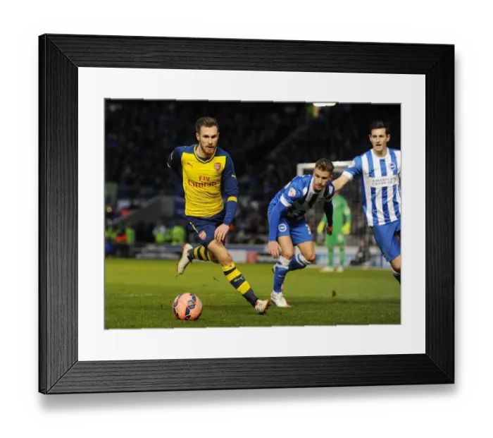 Framed Print : Arsenal's Aaron Ramsey Breaks Past Brighton's Defense in FA Cup Clash