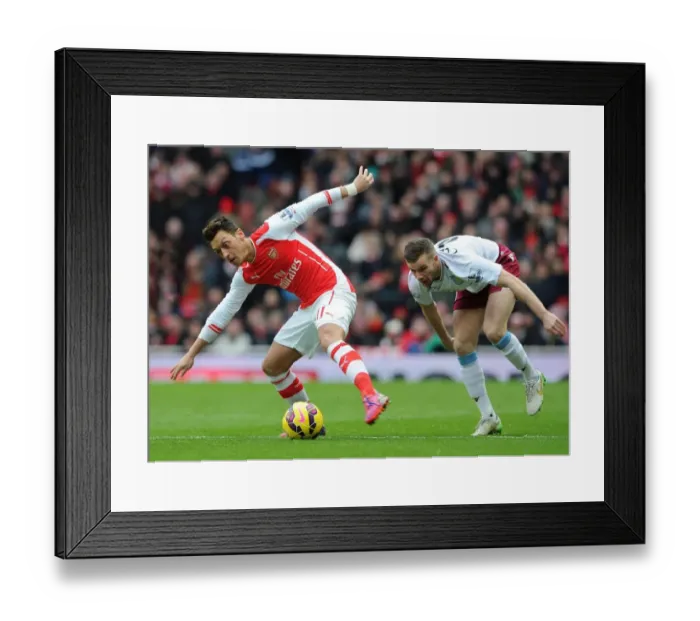 Framed Print : Mesut Ozil vs. Tom Cleverley: Intense Battle at the Emirates, Arsenal vs. Aston Villa, Premier League