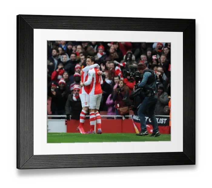 Framed Print : Mesut Ozil celebrates scoring Arsenals 2nd goal with Santi Cazorla. Arsenal 5: 0 Aston Villa