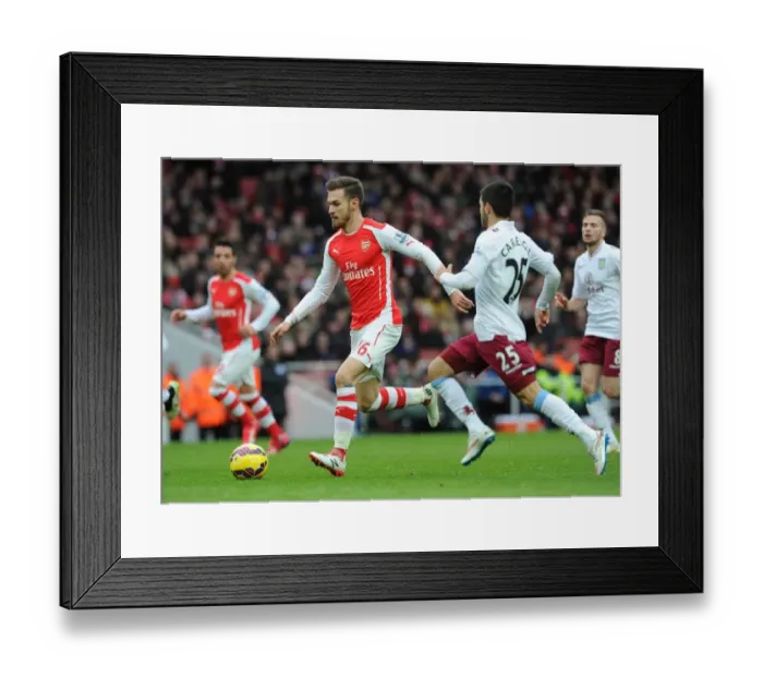 Framed Print : Arsenal's Aaron Ramsey Faces Off Against Aston Villa's Carles Gil in Intense Premier League Clash Framed Print : Arsenal's Aaron Ramsey Faces Off Against Aston Villa's Carles Gil in Intense Premier League Clash
