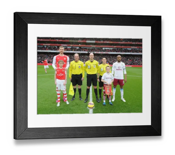 Framed Print : Arsenal vs. Aston Villa: Premier League Clash - Per Mertesacker and Fabian Delph Lead Teams Out at Emirates Stadium Framed Print : Arsenal vs. Aston Villa: Premier League Clash - Per Mertesacker and Fabian Delph Lead Teams Out at Emirates Stadium