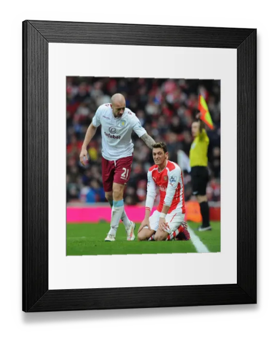 Framed Print : Arsenal vs Aston Villa: Mesut Ozil Fouled by Alan Hutton during the 2014-15 Premier League Match Framed Print : Arsenal vs Aston Villa: Mesut Ozil Fouled by Alan Hutton during the 2014-15 Premier League Match