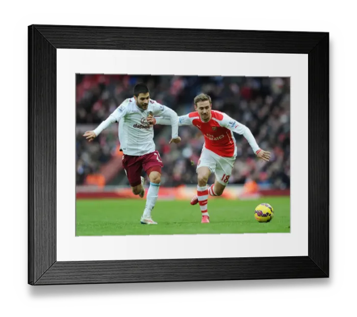 Framed Print : Arsenal's Nacho Monreal Holds Off Aston Villa's Carles Gil During Premier League Clash