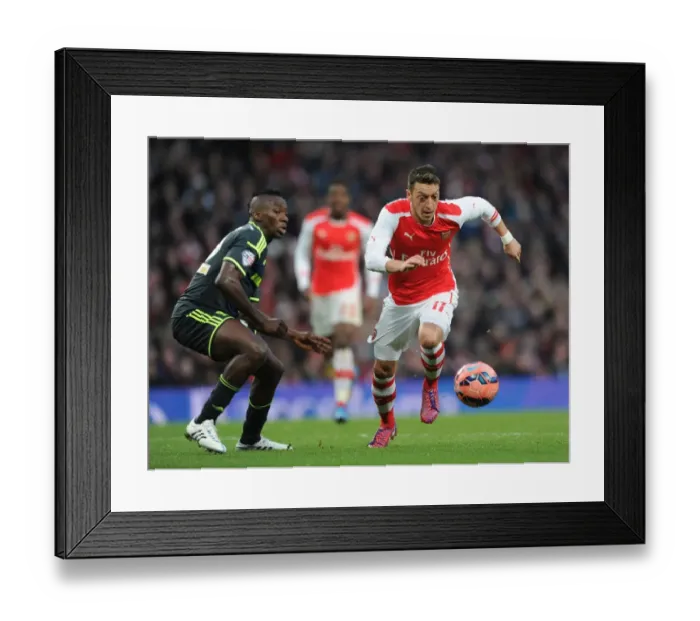 Framed Print : Arsenal's Mesut Ozil Outmaneuvers Middlesbrough's Albert Adomah in FA Cup Fifth Round Clash