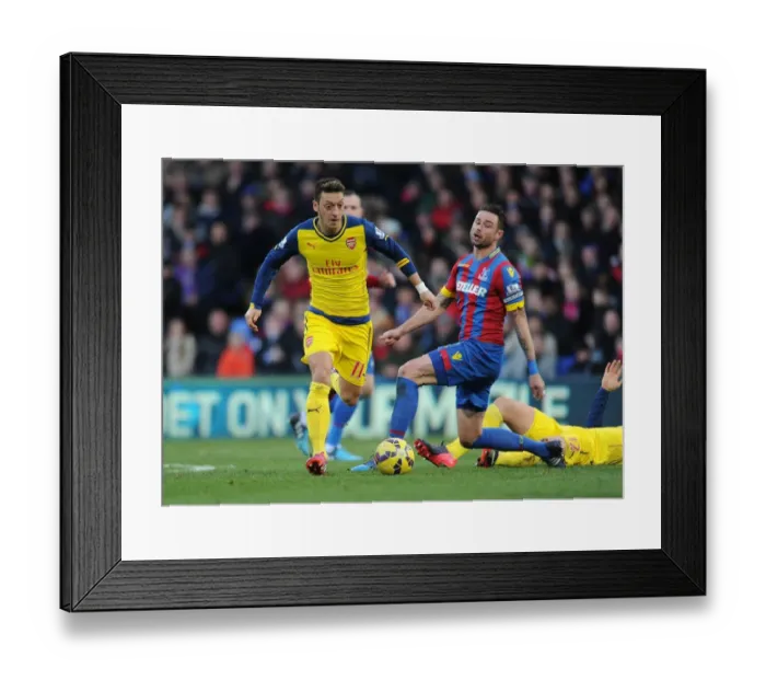 Framed Print : Mesut Ozil Breaks Past Crystal Palace's Damien Delaney during Arsenal's Premier League Victory Framed Print : Mesut Ozil Breaks Past Crystal Palace's Damien Delaney during Arsenal's Premier League Victory
