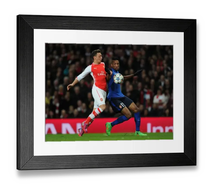 Framed Print : Mesut Ozil vs. Nabil Dirar: Intense Battle in Arsenal's UEFA Champions League Clash with Monaco Framed Print : Mesut Ozil vs. Nabil Dirar: Intense Battle in Arsenal's UEFA Champions League Clash with Monaco