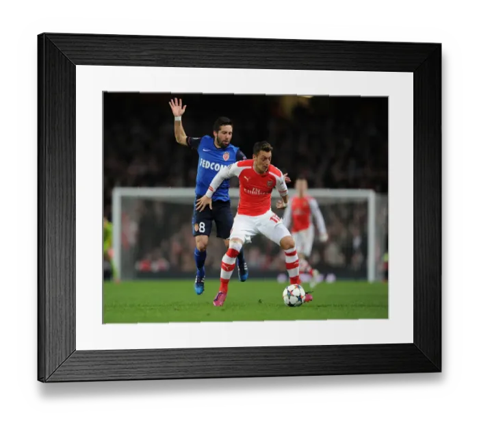 Framed Print : Mesut Ozil Outmaneuvers Joao Moutinho in Arsenal's UEFA Champions League Clash