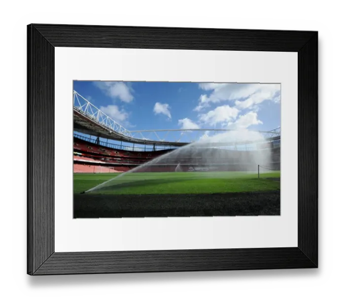 Framed Print : Emirates Stadium pitch is watered before the match. Arsenal 2: 0 Everton. Barclays Premier League