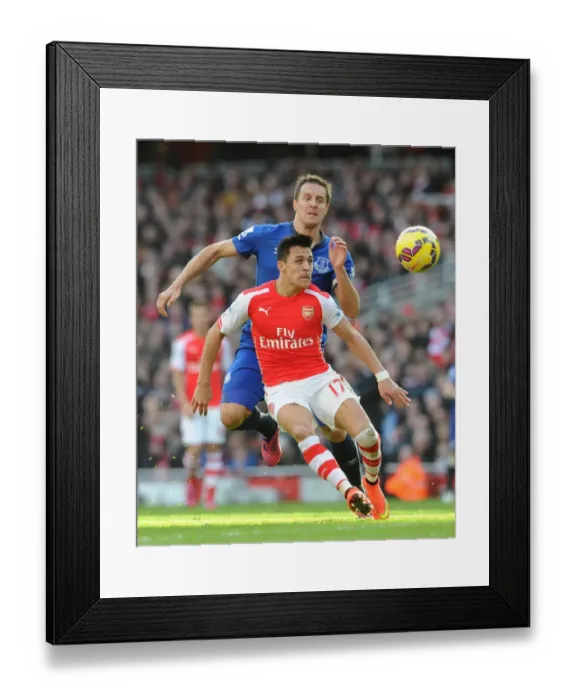 Framed Print : Arsenal's Alexis Sanchez Fends Off Everton's Phil Jagielka in Intense Premier League Clash Framed Print : Arsenal's Alexis Sanchez Fends Off Everton's Phil Jagielka in Intense Premier League Clash