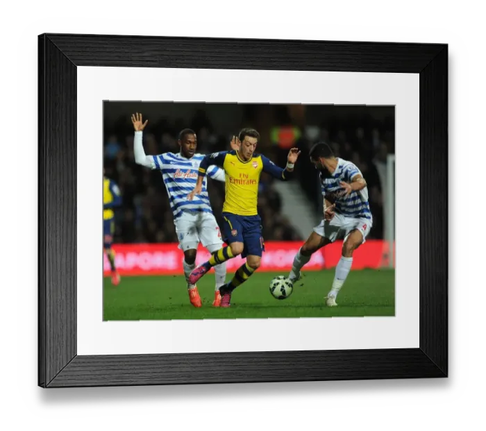 Framed Print : Mesut Ozil Clashes with Junior Hoilett and Steven Caulker during Queens Park Rangers vs Arsenal Premier League Match