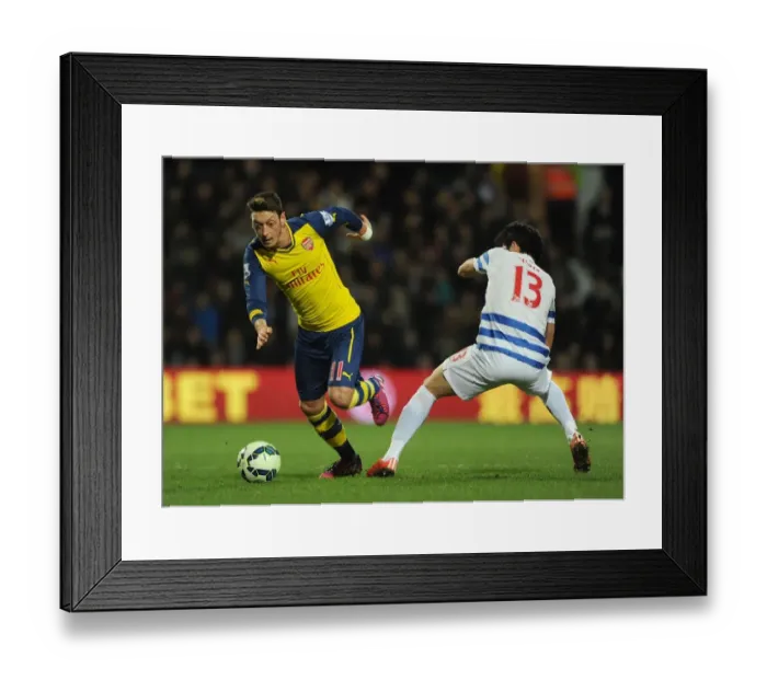 Framed Print : Mesut Ozil vs Suk-Young Yun: A Battle in the Premier League