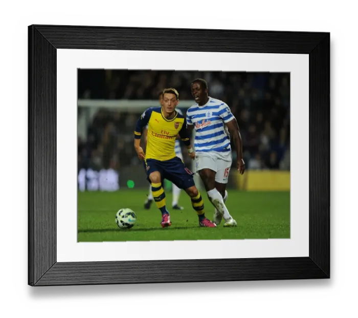 Framed Print : Mesut Ozil vs Nedum Onuoha: Intense Clash Between Queens Park Rangers and Arsenal in the Premier League Framed Print : Mesut Ozil vs Nedum Onuoha: Intense Clash Between Queens Park Rangers and Arsenal in the Premier League
