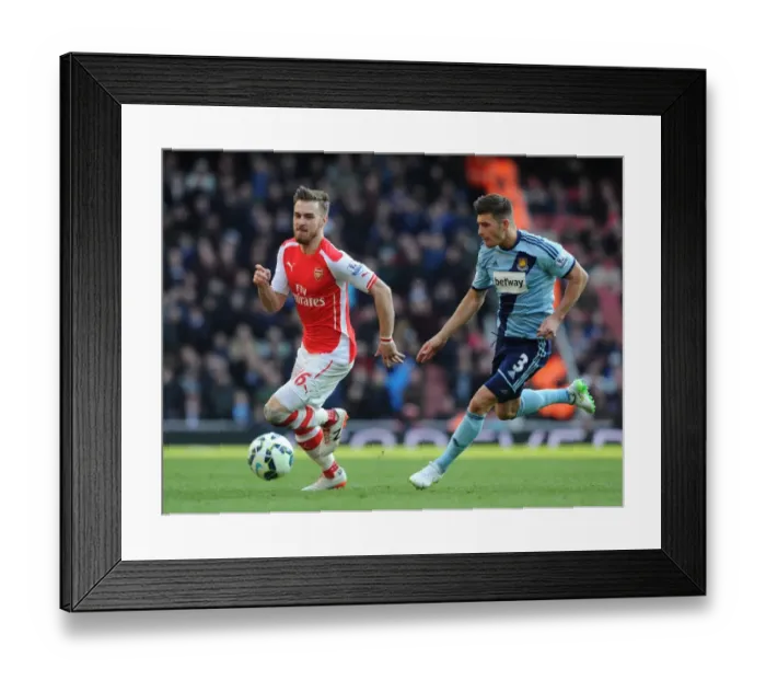 Framed Print : Arsenal's Aaron Ramsey Faces Off Against West Ham's Aaron Creswell in Premier League Clash Framed Print : Arsenal's Aaron Ramsey Faces Off Against West Ham's Aaron Creswell in Premier League Clash