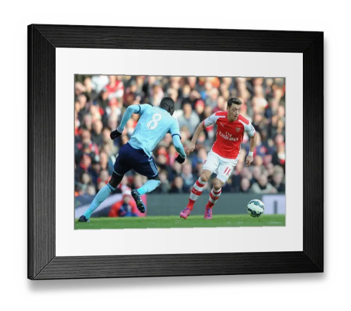 Framed Print : Arsenal vs. West Ham United: Mesut Ozil Faces Off Against Cheikhou Kouyate in Premier League Clash
