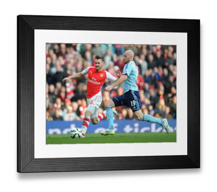 Framed Print : Arsenal's Ramsey Scores Past Collins in Arsenal v West Ham Premier League Clash Framed Print : Arsenal's Ramsey Scores Past Collins in Arsenal v West Ham Premier League Clash