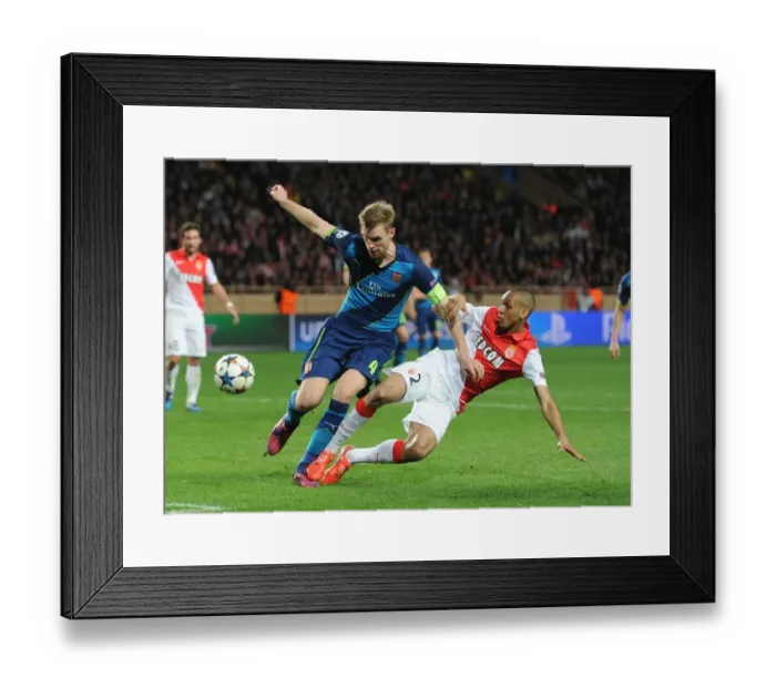 Framed Print : Mertesacker vs Fabinho: Intense Clash in Monaco's UCL Showdown against Arsenal Framed Print : Mertesacker vs Fabinho: Intense Clash in Monaco's UCL Showdown against Arsenal