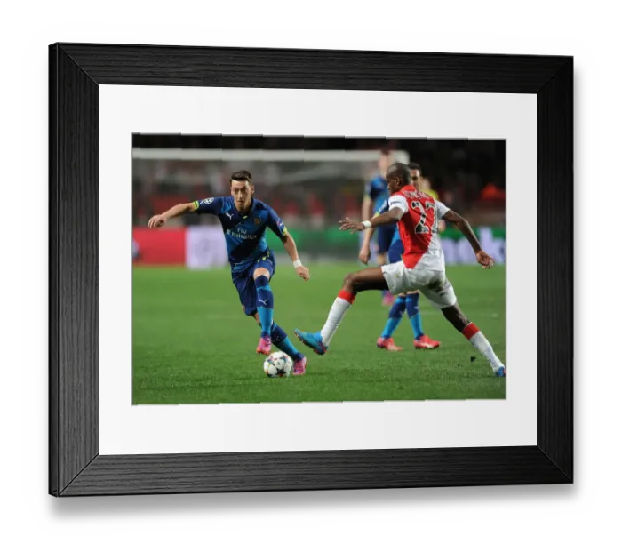 Framed Print : Mesut Ozil Breaks Past Monaco's Geoffrey Kondogbia: Arsenal vs Monaco, UEFA Champions League Round of 16, March 2015